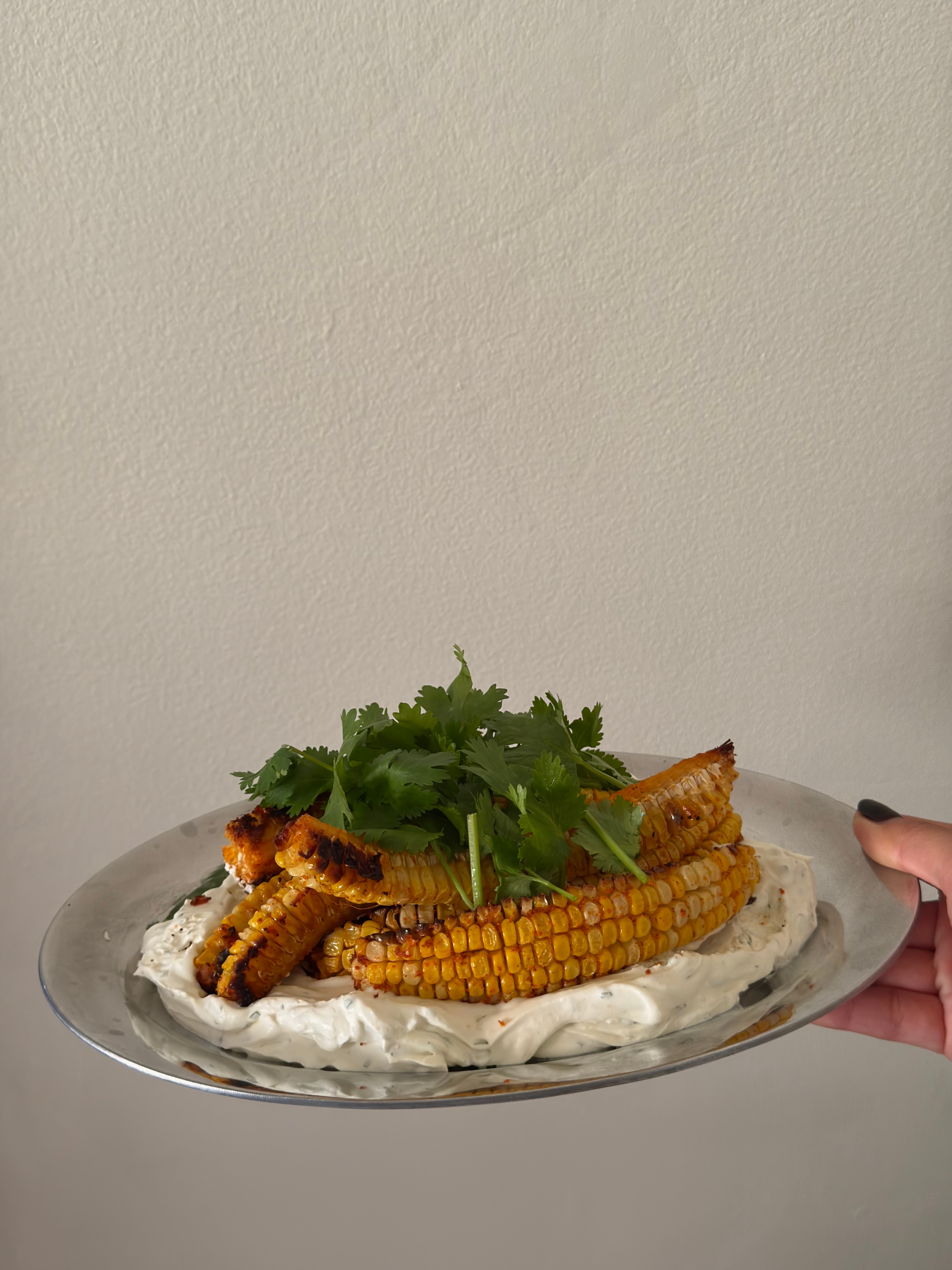 Grilled corn with herbs on a platter from By Mei Mei