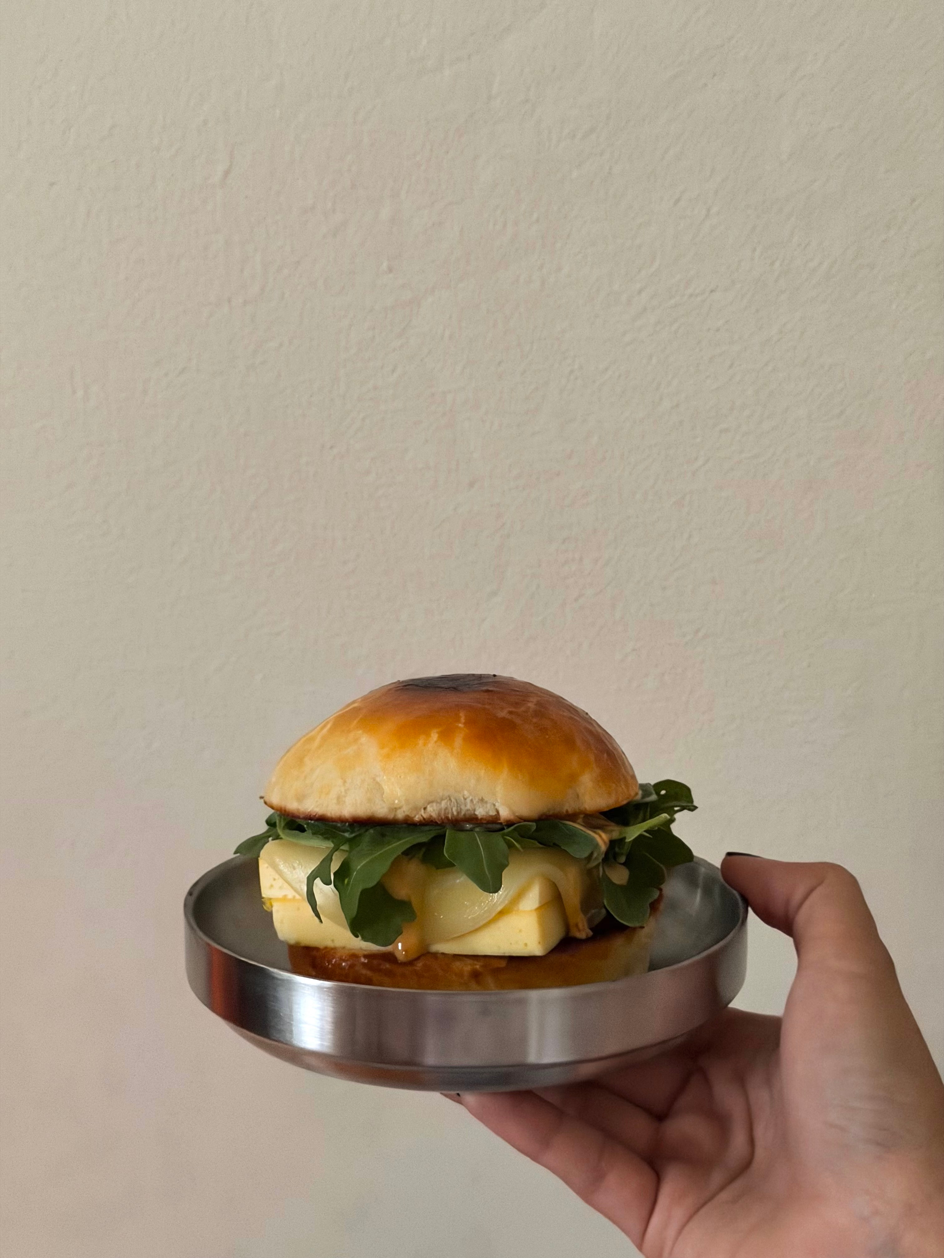 Breakfast sandwich on a metal plate from By Mei Mei