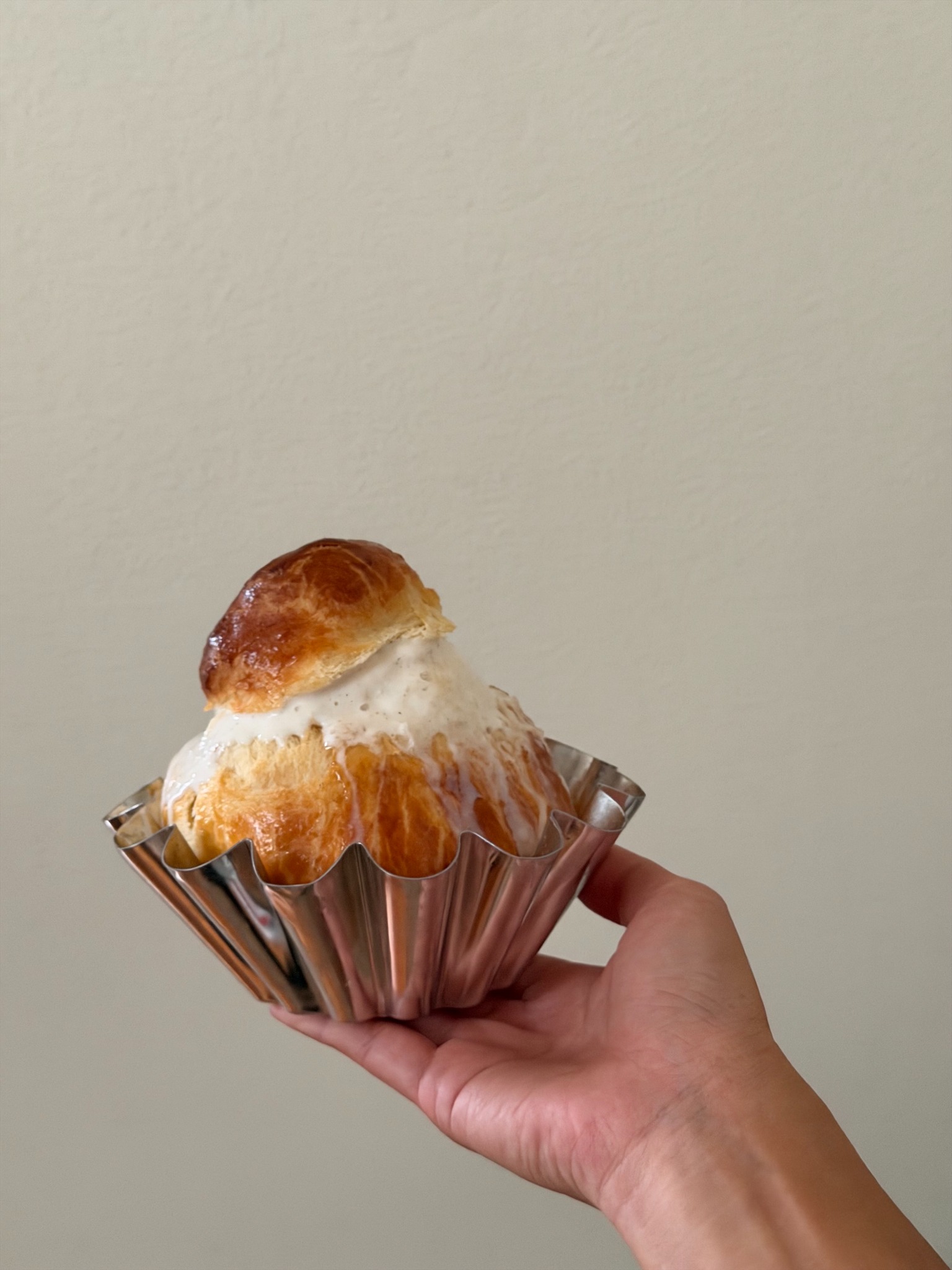 Cream-filled pastry in a metal mold from By Mei Mei
